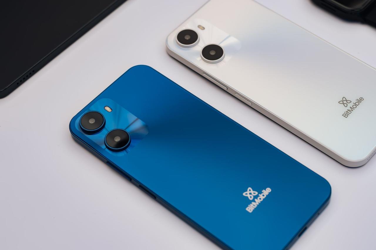 Blue and white Phēnix X smartphone featuring the BitMobile logo, the device that comes preloaded with the AstraBit app in select African markets.